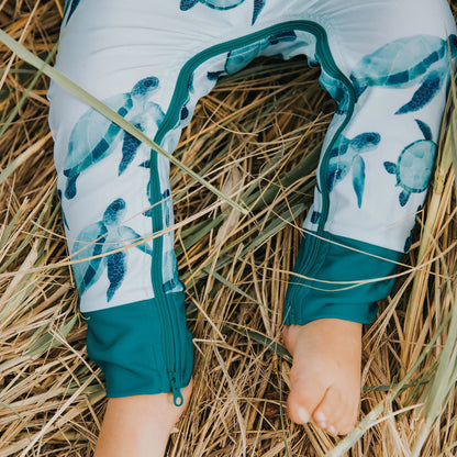 UPF 50+ protective full length, long sleeve swimsuit. Turtle print with zipper that goes around the legs of the suit making nappy changes very easy. 
